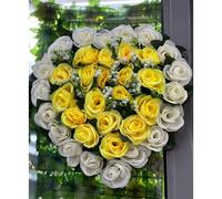 Artificial Rose flowers in the shape of a heart for a memorial grave or funeral