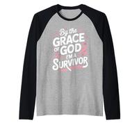by The Grace of God I'm A Survivor Faith Raglan Baseball Tee