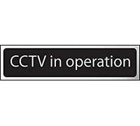 Centurion 6426C CCTV In Operation Sign - Self-Adhesive PVC - Black and Chrome Effect - 200mm x 50mm