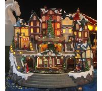 Christmas Village Houses Decoration with Moving Train, Music, LED Lights, and Rotatable Christmas Tree - Chargeable Ornament for Holiday Festivities