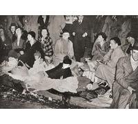 Crowds in Piccadilly London England at 3 a.m. in the morning waiting for the Coronation procession of George VI and Queen Elizabeth London England 1937. From The Coronation in Pictures published 1937