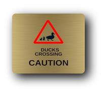 Duck crossing caution sign, indicating the presence of ducks crossing a road or path. Sign - 9.5x9.5cm Brushed Aluminium