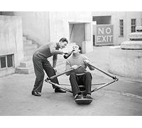 Holy Mackerel a drink for the oarsman retro black and white photographic card featuring a vintage image of a man swigging beer on a rowing machine - 12.6 x 17.7cm and blank inside