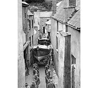 Holy Mackerel Cornish lifeboat retro black and white photographic card featuring a vintage image of a boat being hauled through a narrow street in Cornwall - 12.6 x 17.7cm and blank inside