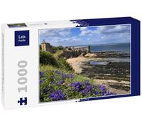 Lais Puzzle St Andrews Castle ruins on rocky North Sea coast with view of Castle Sands beach in St Andrews Fife Scotland UK with purple geraniums 1000 pieces