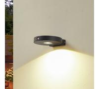 Lucande LED solar wall lamp Tavon, round, black, sensor
