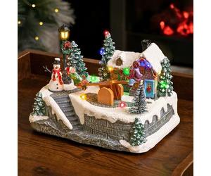 Marco Paul Animated See-Saw Christmas Village Scene - Large 15cm Musical Christmas Ornaments with Multi-Coloured LED Lights - Battery Operated Light Up Xmas Ornaments