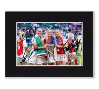McCabe, Kelly & Foord Arsenal Ladies - 2025 Champions League Winner Signed 8x6 Inch Mounted Photo Print With Pre Printed Signatures That Would Make A Great Gift For Any Fan And Is Ready To Be Framed.