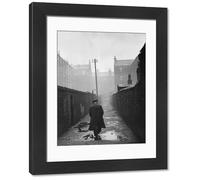Media Storehouse Framed 16x12 Photo of A man walking through a backstreet of the Gorbals area of Glasgow (11675126)