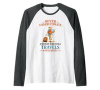 Never Underestimate a Woman Who Still Travels in Her 80's Raglan Baseball Tee