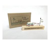 on the quayside great adventures await wooden caravan