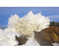 Powerful waves crashing against rocks in Shore Acres State Park as tourists stand at a lookout point watching the intense Oregon coast splash; Oregon United States of America Poster Print by Craig