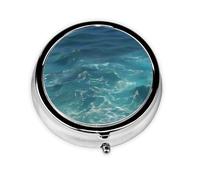 The Deep Ocean A Round Mini Pillbox with Three Compartments for Storing Vitamins, Fish Oil, and Nutritional Supplements.