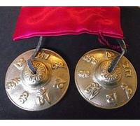 Tibetan Buddhist Hand Bells embossed with the Mantra of the Buddha of Compassion 'OM MANI PADME HUM' ; 60mm Diameter. Comes in a Satin Drawnstring Carry Pouch