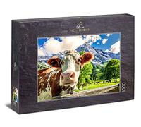 Ulmer Puzzleschmiede - Puzzle "Cows and mountains": 1000 pieces jigsaw puzzle - A curious cow in front of a dreamlike mountain scenery in the Alps