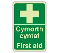 V Safety First Aid Sign - 200 x 300 mm - Welsh/English - Double Glow Rigid | Glow In The Dark | Double Glow Rigid Plastic | First Aid Signage - Made in Britain