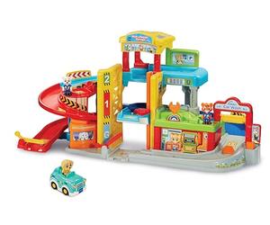 VTech Toot-Toot Drivers Roll & Repair Garage, English | Garage with 3D dog roadster, light-up play, 7 SmartPoints and multiple play areas; connects to all play sets. Ages 1-5