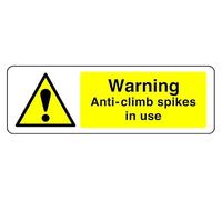 Warning Anti-Climb Spikes In Use - safety sign - High tack self-adhesive sticker (150mm x 50mm) Viewing Distance within 3m.