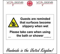 WS775 Warning Sign Guests are Reminded That Surfaces Become Slippery When Wet Please TAKE Care When Using The Bath OR Shower 200mm x 100mm .Sticker/SAV - White Background